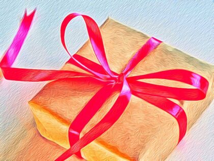 picture of a gift wrapped in gold paper and tied with a red ribbon